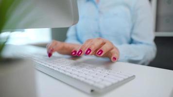 Female hands with bright manicure typing on a computer keyboard video