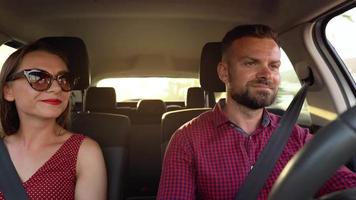Beautiful couple rides in a car and admires the surrounding views video