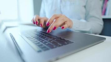 Female hands with bright manicure typing on a computer keyboard video