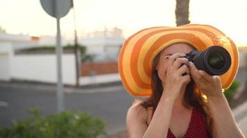 Photographer tourist woman taking photos with camera in a beautiful tropical landscape at sunset video