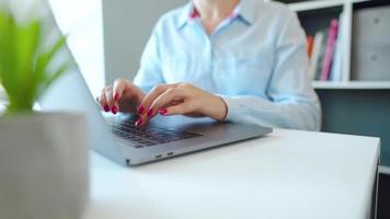 Female hands with bright manicure typing on a computer keyboard video