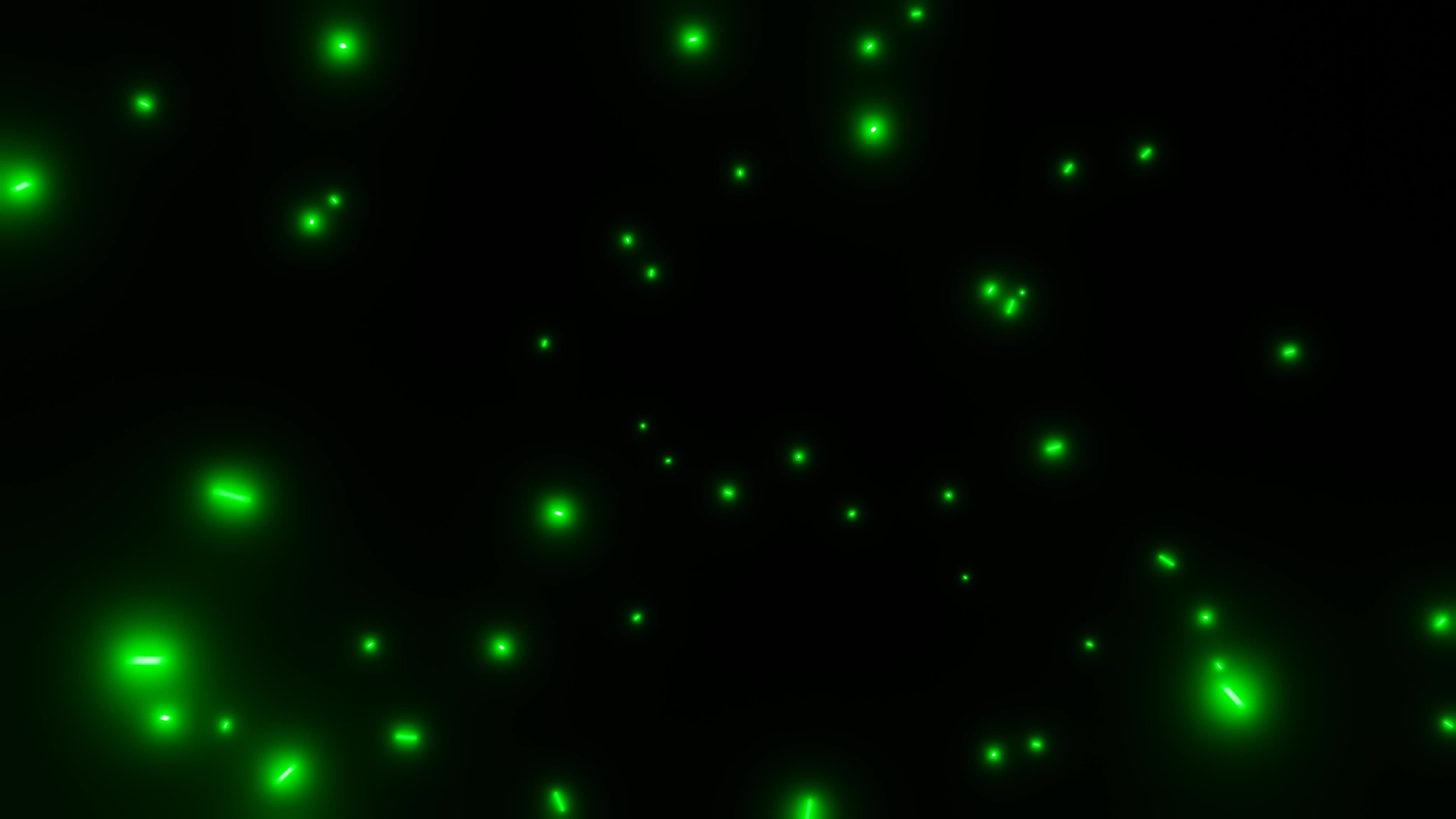 motion glowing particles of green light flying in the dark abstract