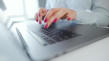 Female hands with bright manicure typing on a computer keyboard video