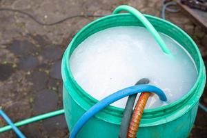 exterminate termite control company employee is using a termite sprayer at customer's house and searching for termite nests to eliminate. exterminate control worker spraying chemical insect repellant photo