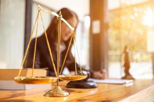 Brass court scales are used to decorate a table in a legal advisor office for aesthetic reasons ,Because the brass court scales are a symbol of justice. legal advisor concept. photo