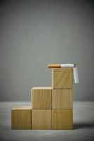 There broken cigarette at top of wooden cube ladder.Concept, World no tobacco Day. photo
