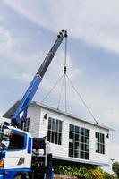 Crane lifting a knock down private house. photo