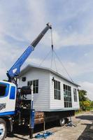 Crane lifting a knock down private house. photo