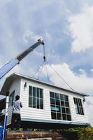 Crane lifting a knock down private house. photo