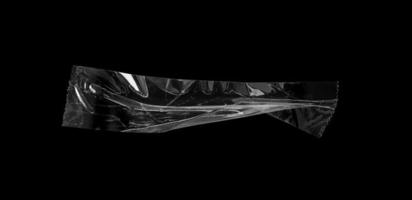 adhesive plastic tape isolated on black background photo
