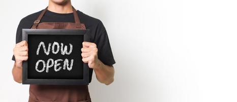 Cropped portrait of Asian barista man holding a blackboard holding a blackboard that says Now Open good for banner. Isolated image on white background. photo