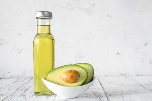 Bottle of avocado oil with fresh avocado photo
