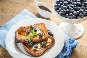 French toasts with fresh blueberries and maple syrup photo