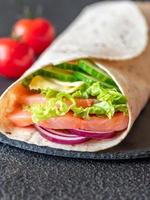 tortilla envolver con salmón y vegetales foto