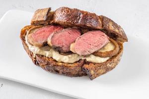 Sandwich with beef steak and mushrooms photo