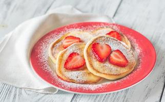 Portion of ricotta fritters with fresh strawberries photo