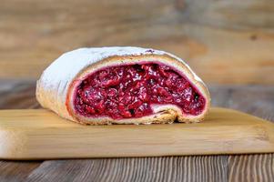 Cherry strudel on wooden background photo