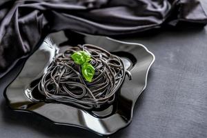 Pasta with wheat germ and black cuttlefish ink photo