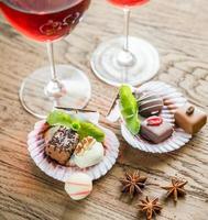 Luxury chocolate candies with two glasses of wine photo