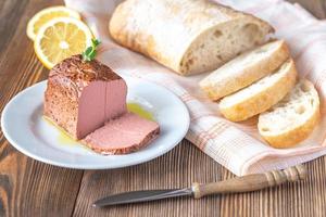 Chicken liver pate on the white plate photo