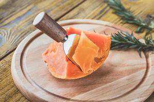 Mimolette cheese on the wooden board photo