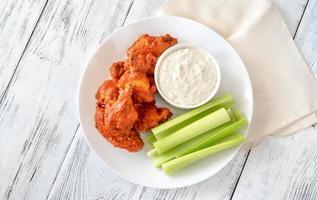 Bowl of buffalo wings with blue cheese dip photo