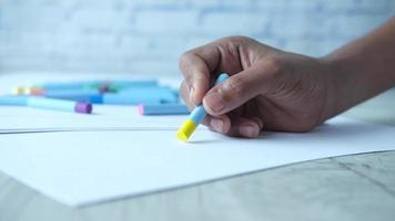 A boy drawing with colored pastel on a page video