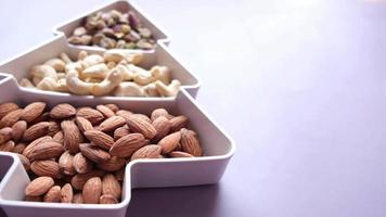 walnoot, cashewnoot en amandel in een container op tafel video