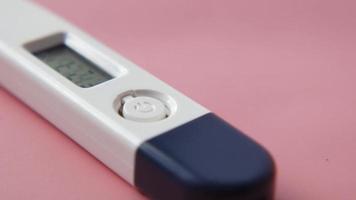 digital thermometer on pink background with copy space video