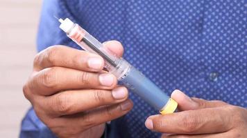 hand holding Insulin pen video