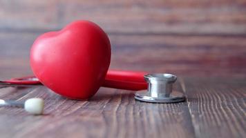heart shape symbol and stethoscope on wooden background video