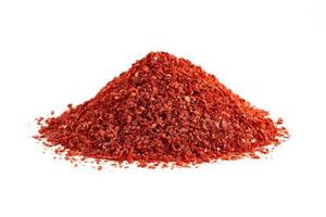 dry red chili pepper flake or ground powder coarse paprika isolated on white background. pile of red chili pepper flake or ground powder coarse paprika isolated. red chili pepper flake ground paprika. photo