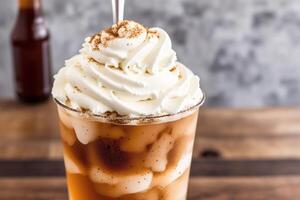 Iced coffee with whipped cream in a glass on a wooden table. photo