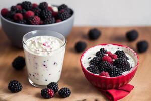 Strawberry yogurt in a white bowl.Yogurt with fresh blackberries, raspberries. photo