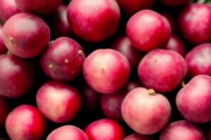 delicious Cranberries in a bowl on a wooden table, top view. Black currant berries. Healthy food concept. photo