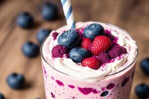 A glass of milkshake with whipped cream and blackberries.Strawberry milkshake, Raspberry milkshake. photo