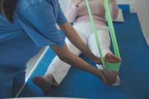 Patient doing some special exercises under supervision in a room photo