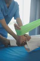 Patient doing some special exercises under supervision in a room photo