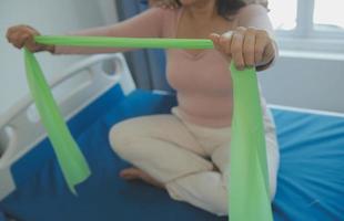 Patient doing some special exercises under supervision in a room photo