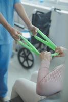 Patient doing some special exercises under supervision in a room photo