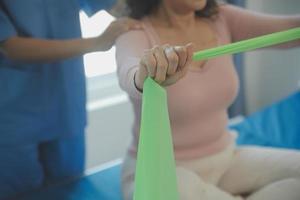 Patient doing some special exercises under supervision in a room photo