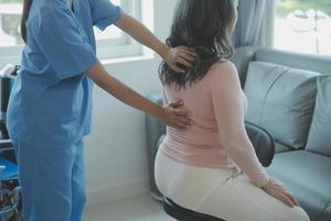 Patient doing some special exercises under supervision in a room photo