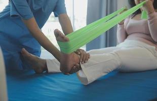 Patient doing some special exercises under supervision in a room photo