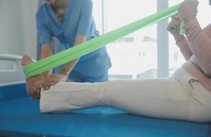 Patient doing some special exercises under supervision in a room photo