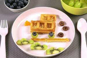 Car waffle for children's breakfast. A creative idea for a fun kids dessert or breakfast photo