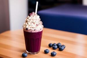 A glass of milkshake with whipped cream and blackberries.Strawberry milkshake, Raspberry milkshake. photo