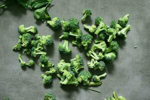 fresh broccoli green cutlets on concrete background photo