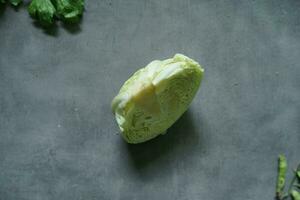 fresh cabbage and fresh vegetables from top view on concerete background photo