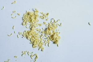 Raw yellow instant noodles ready to cook on a plain background photo