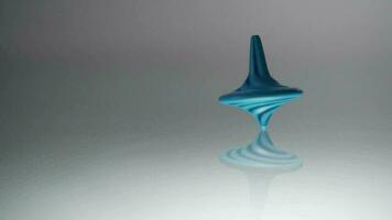 Blue spinning top spinning. Whirligig in action is reflected on mirror grey surface. Slow motion video